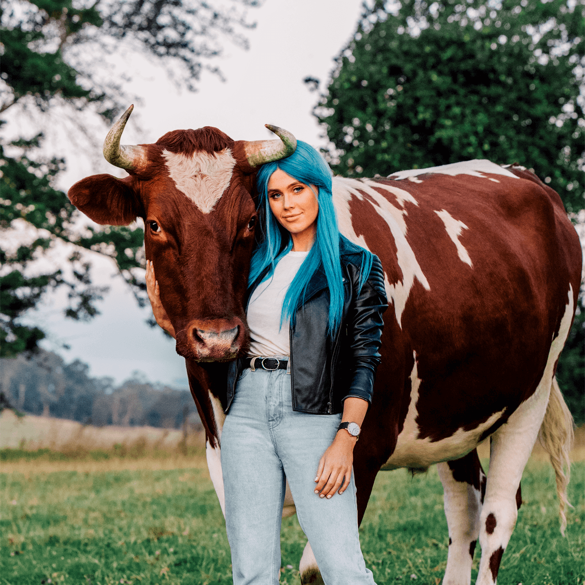 Dara Hayes, AKA DJ Tigerlily, with rescue cow (image by Noah Hannibal)