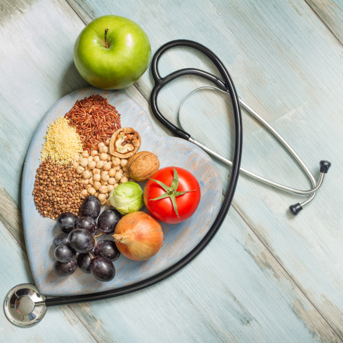 Doctor's stethoscope surrounding healthy plant foods