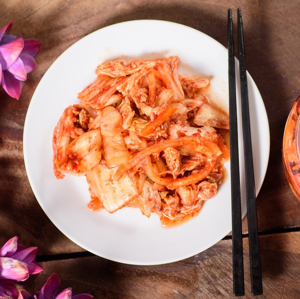 Korean food, kimchi cabbage on white dish and a jar with chopsticks for eating,top view of food